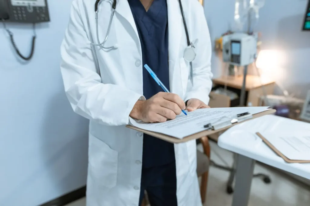 Medic completând documente medicale